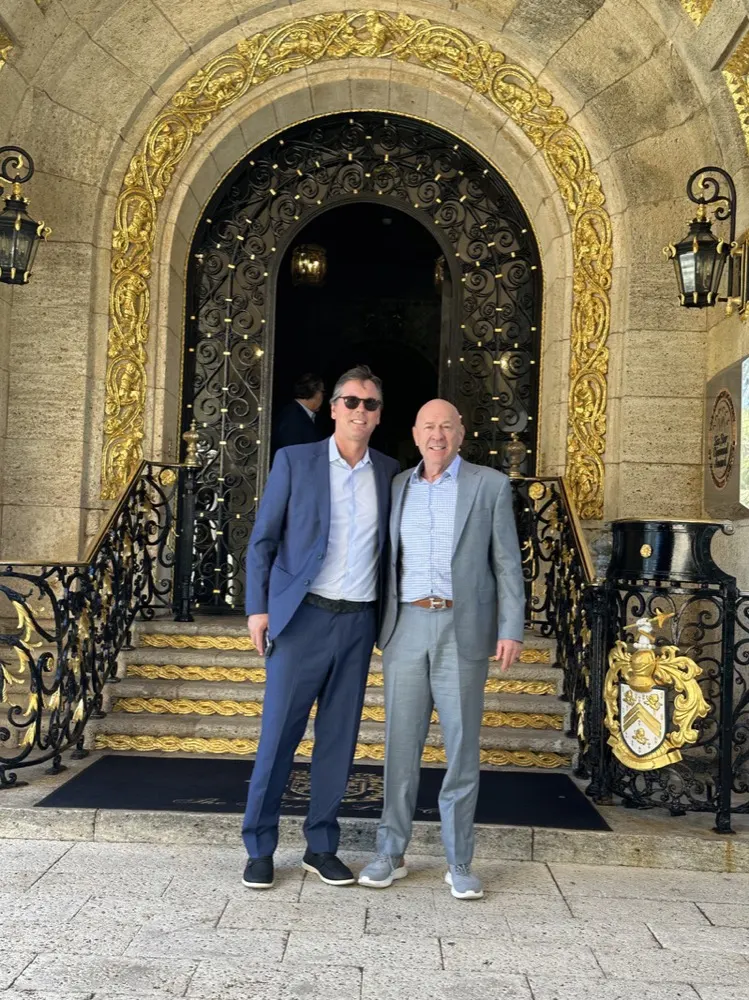 Martin Sumichrast on the steps of a gilded entrance